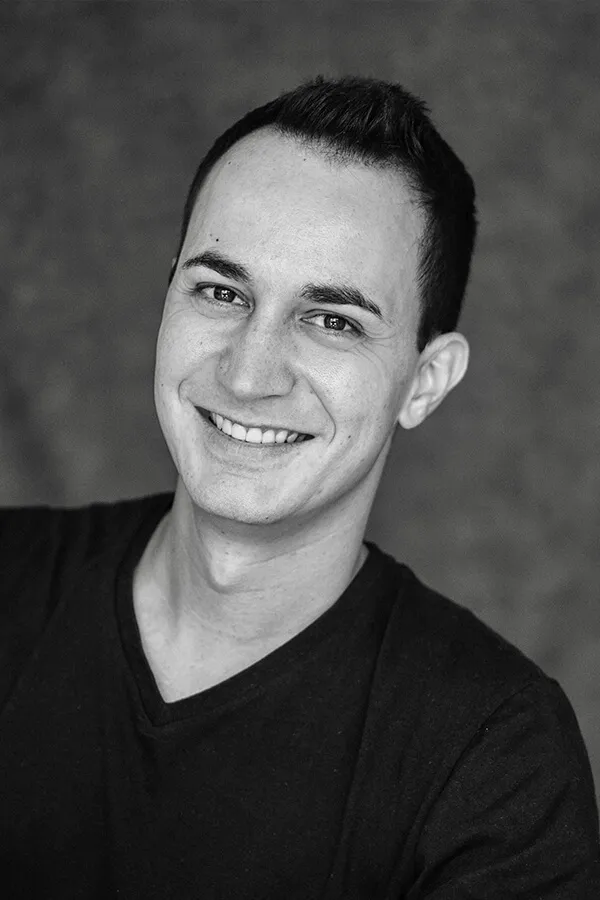 Retrato en blanco y negro sonriendo, camiseta negra